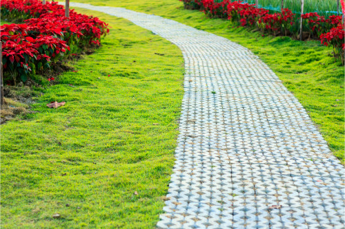 Image of a paved path running through green grass